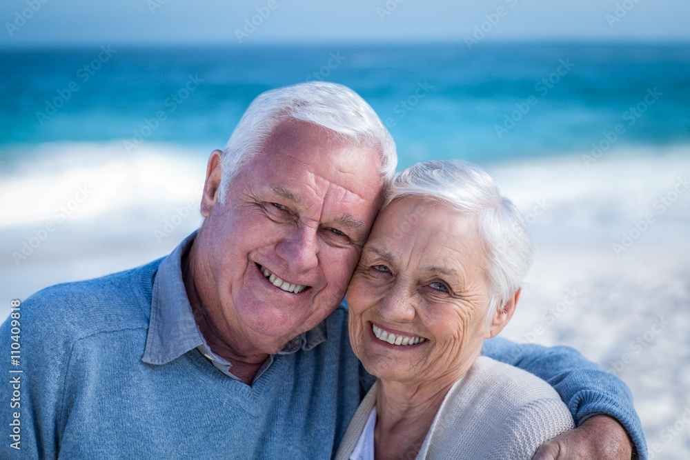 Cute mature couple embracing on the beach