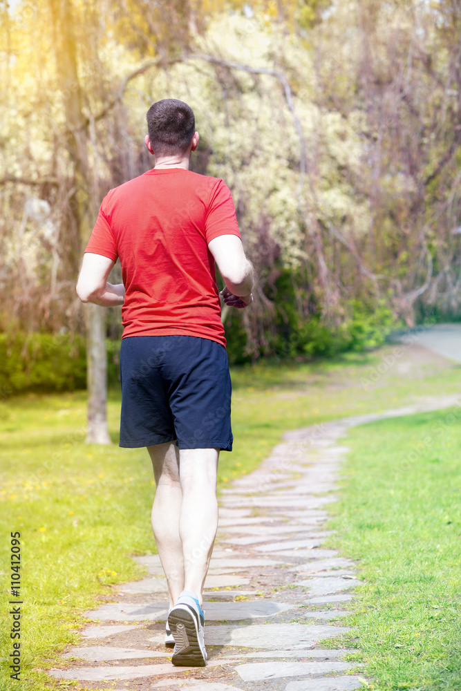 man jogging outdoors in a park