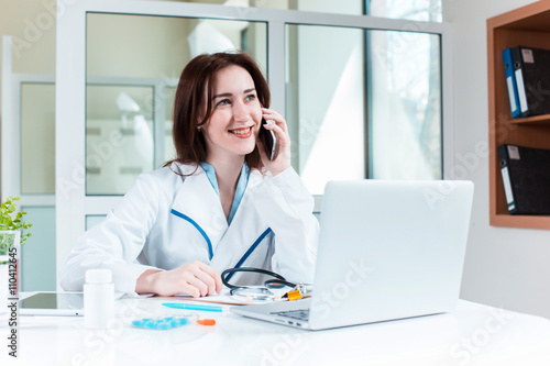 Woman doctor sitting at the table