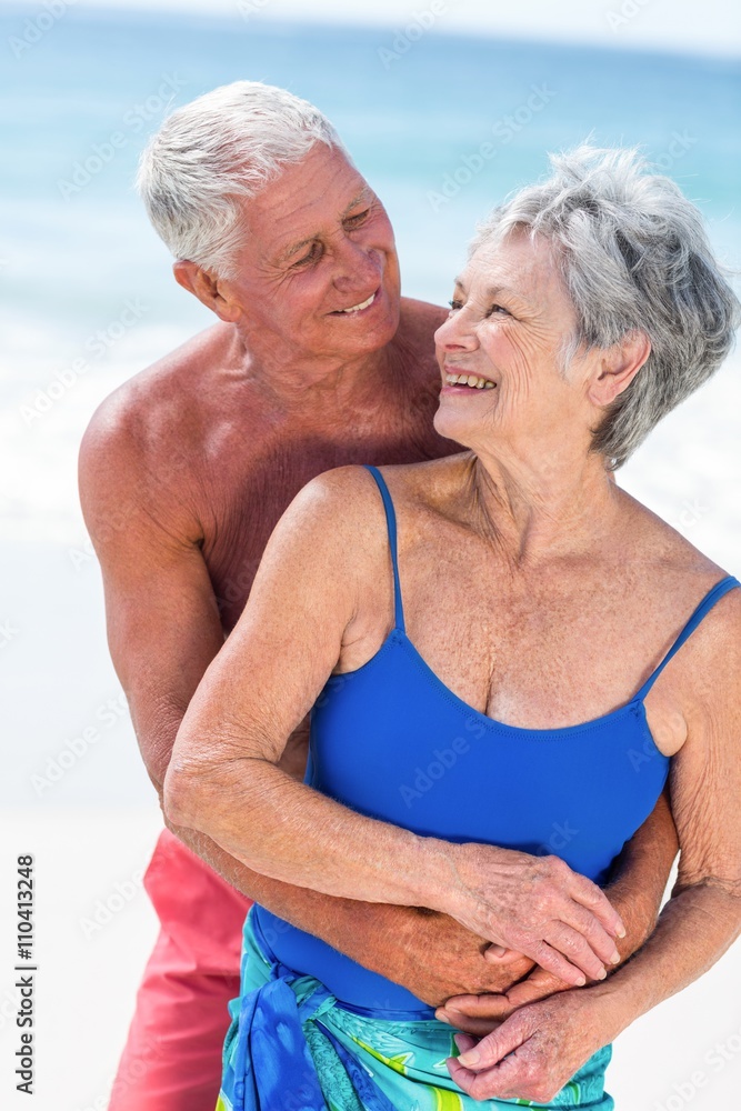 Cute mature couple embracing on the beach Cute mature couple embracing on the beach