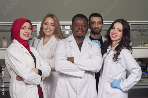 Group of young medical workers are working in lab as lab technicians