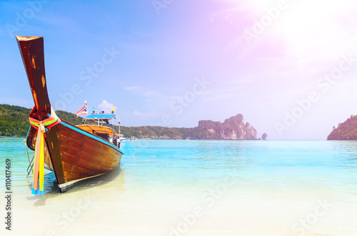long boat at the beach with lens flare at koh Phi-Phi, Thailand © Sergey Peterman