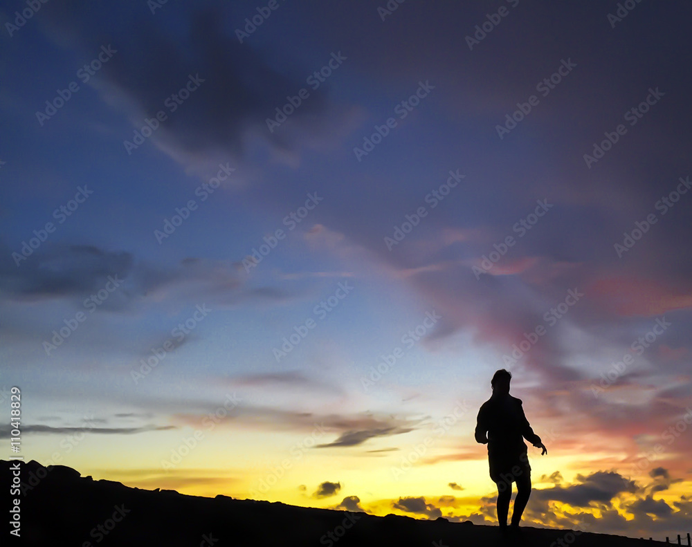 Girl at Sunset on a mountain ridge.