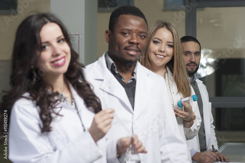 Group of young medical workers are working in lab as lab technic