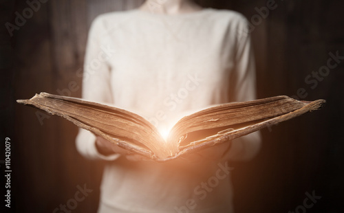 woman hands on bible. she is reading and praying over bible in a photo