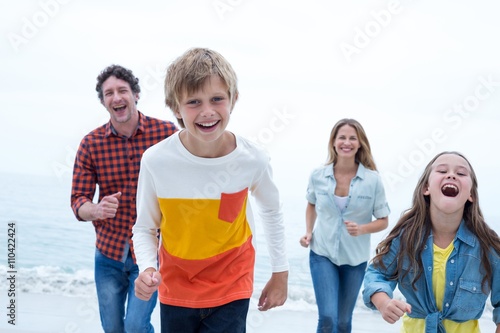 Cheerful family running at beach