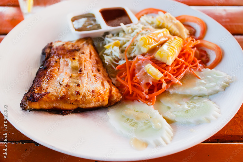 Salmon steak with fresh salad leaf. Salmon steak with fresh salad leaf.
