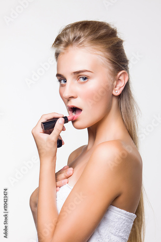 beautiful girl doing make-up on a white background