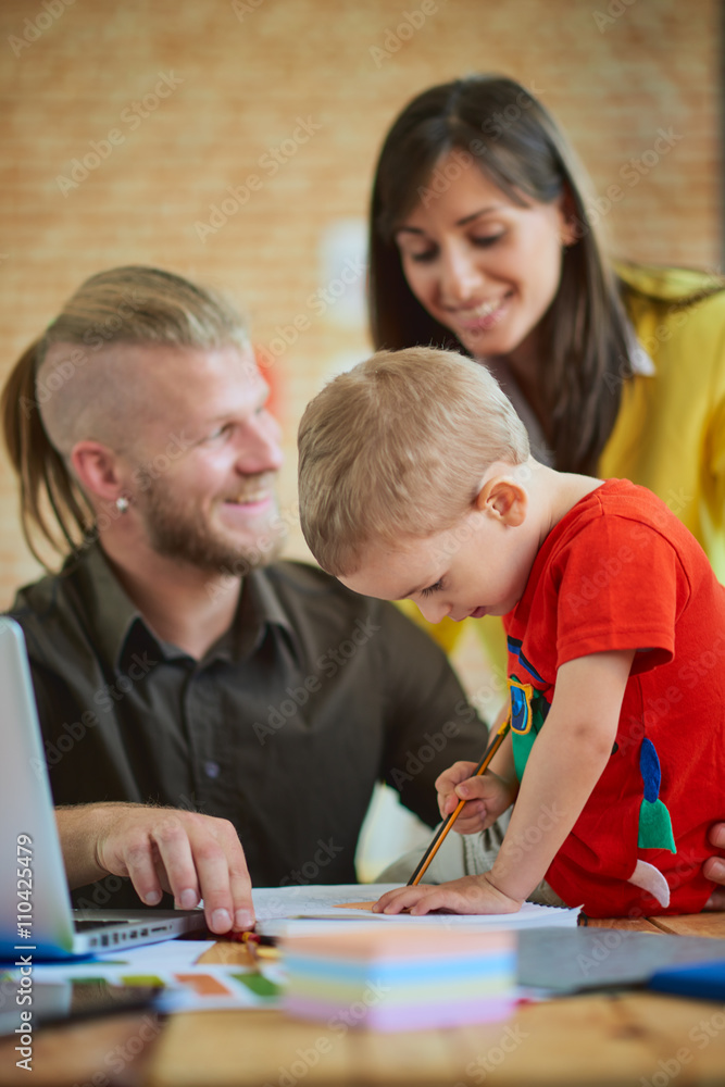 Family business start up concept, man working in home office, mother with son helping him. Family business start up concept, man working in home office, mother with son helping him.