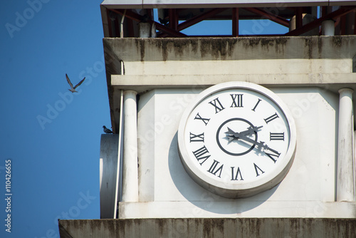 Clock tower under a bright light photo