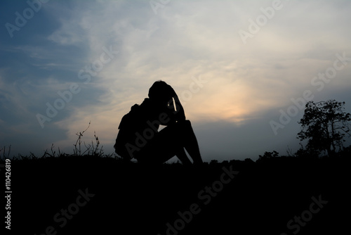 Obraz na plátně Silhouette man desperate sunset background.