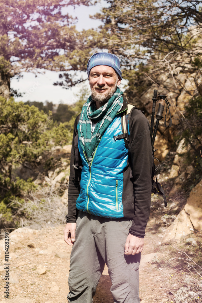 Naklejka premium Bearded hiker laughs.