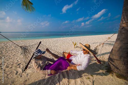 Romantic Couple Relaxing In Beach Hammock