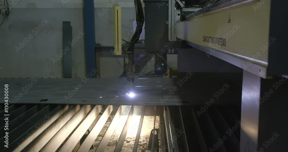 Ray of lights underneath the metal sheet coming from the metal milling machine that creates pattern on the metal sheet Ray of lights underneath the metal sheet coming from the metal milling machine that creates pattern on the metal sheet