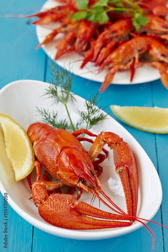 Fine crustacean for dinner. Boiled lobster and crayfish with lemon. Fine crustacean for dinner. Boiled lobster and crayfish with lemon.