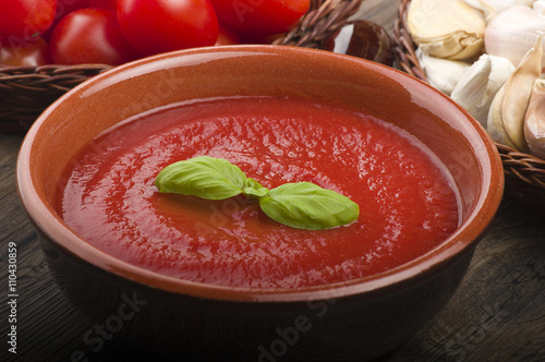  pot with tomato sauce and basil leaves photo