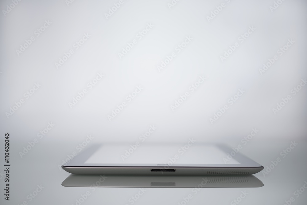 Workspace Designer Smartphone and tablet computer on a mirrored table Workspace Designer Smartphone and tablet computer on a mirrored table