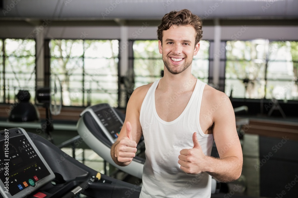 Happy man showing his thumbs up at gym Happy man showing his thumbs up at gym