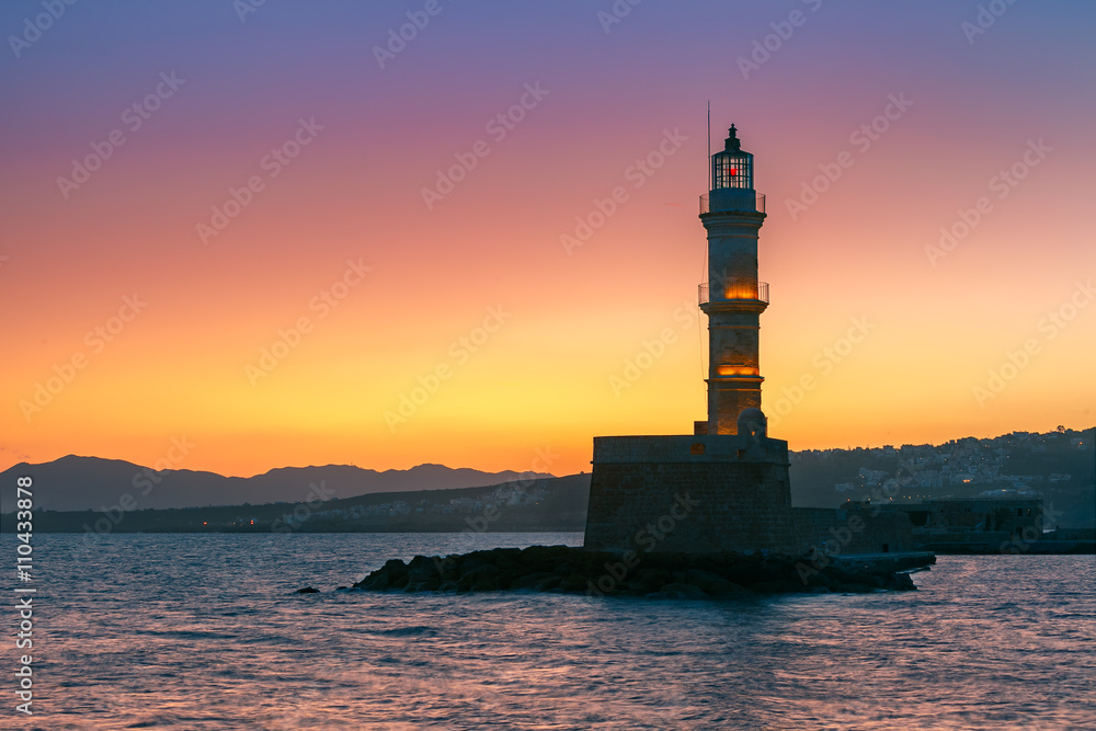 Lighthouse in old harbour of Chania at sunrise, Crete, Greece