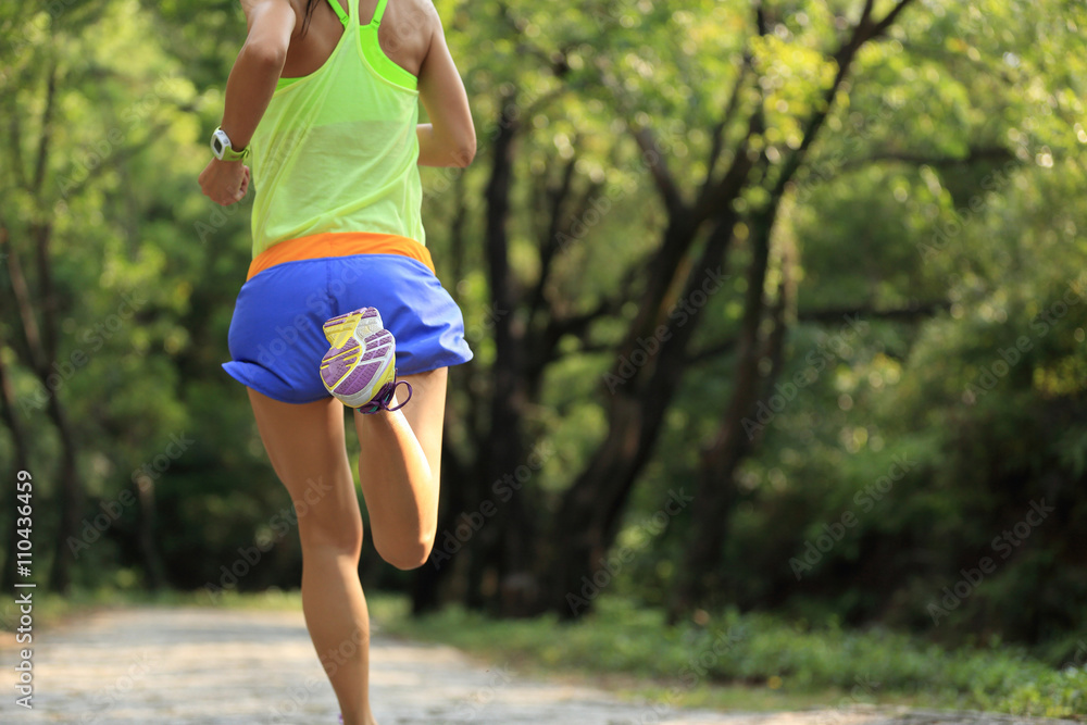 young fitness woman runner running in forest young fitness woman runner running in forest