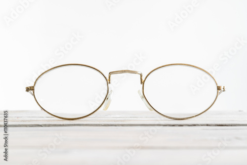 Eyeglasses on a wooden desk