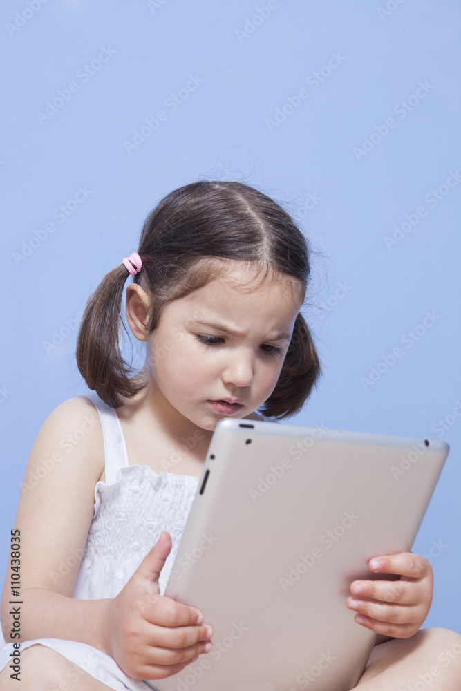 Little girl using tablet computer Little girl using tablet computer