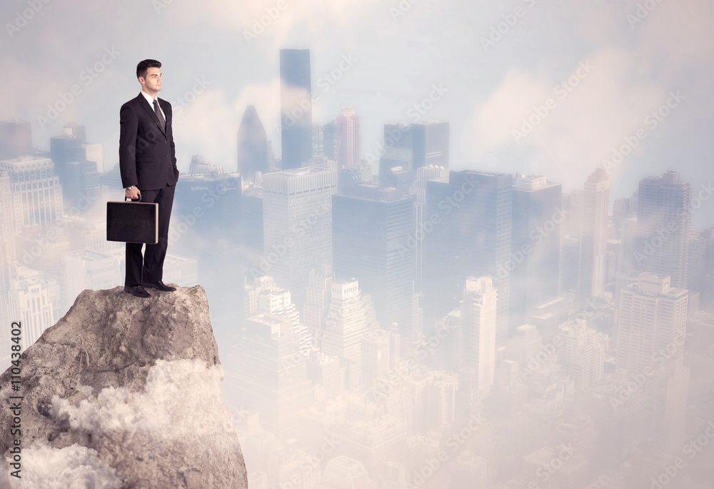 Winner urban businessman on top of stone Winner urban businessman on top of stone