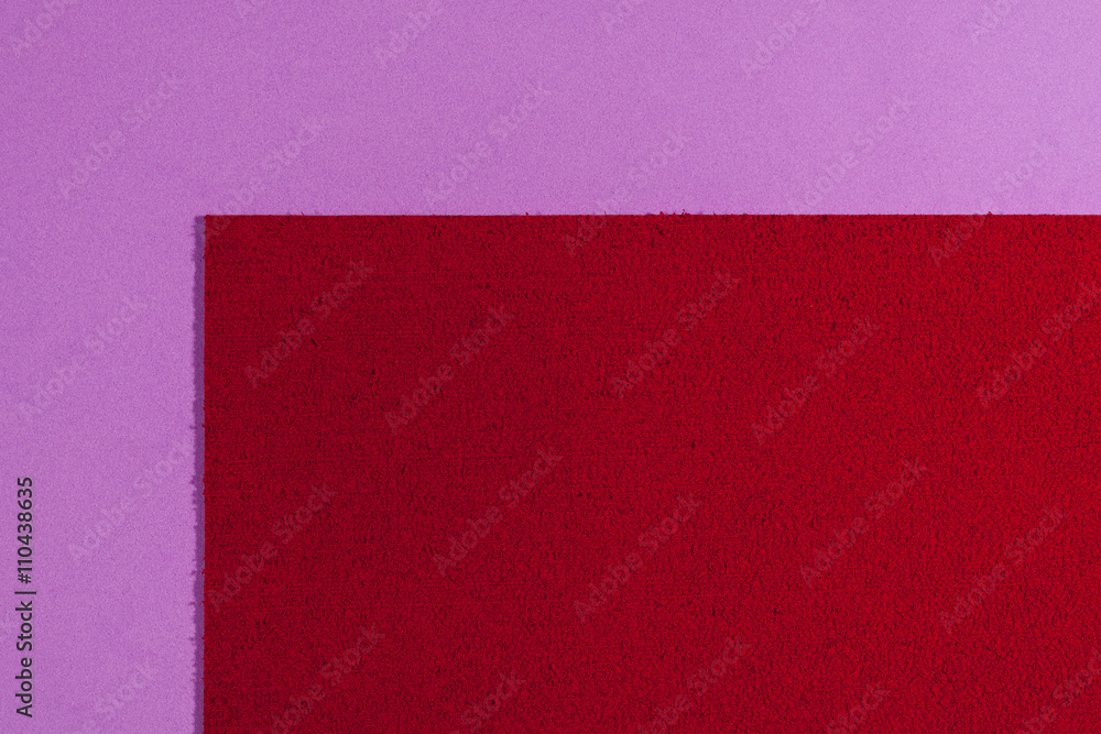 Eva foam ethylene vinyl acetate sponge plush red surface on light purple smooth background Eva foam ethylene vinyl acetate sponge plush red surface on light purple smooth background