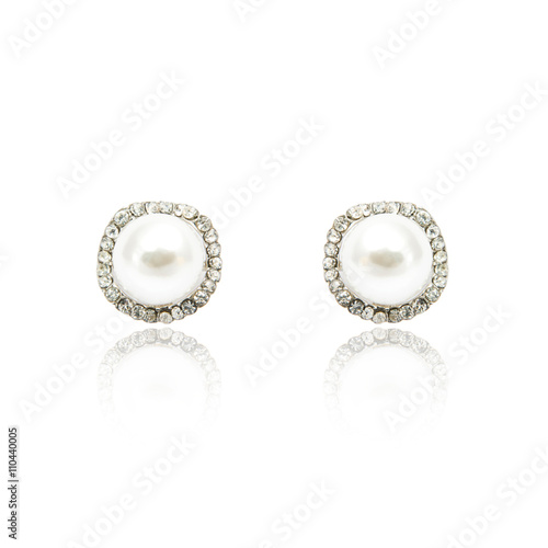 Pair of diamond and natural pearls earrings isolated on white