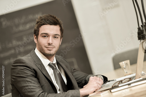 Portrait of smiling Businessman posing in coworking office