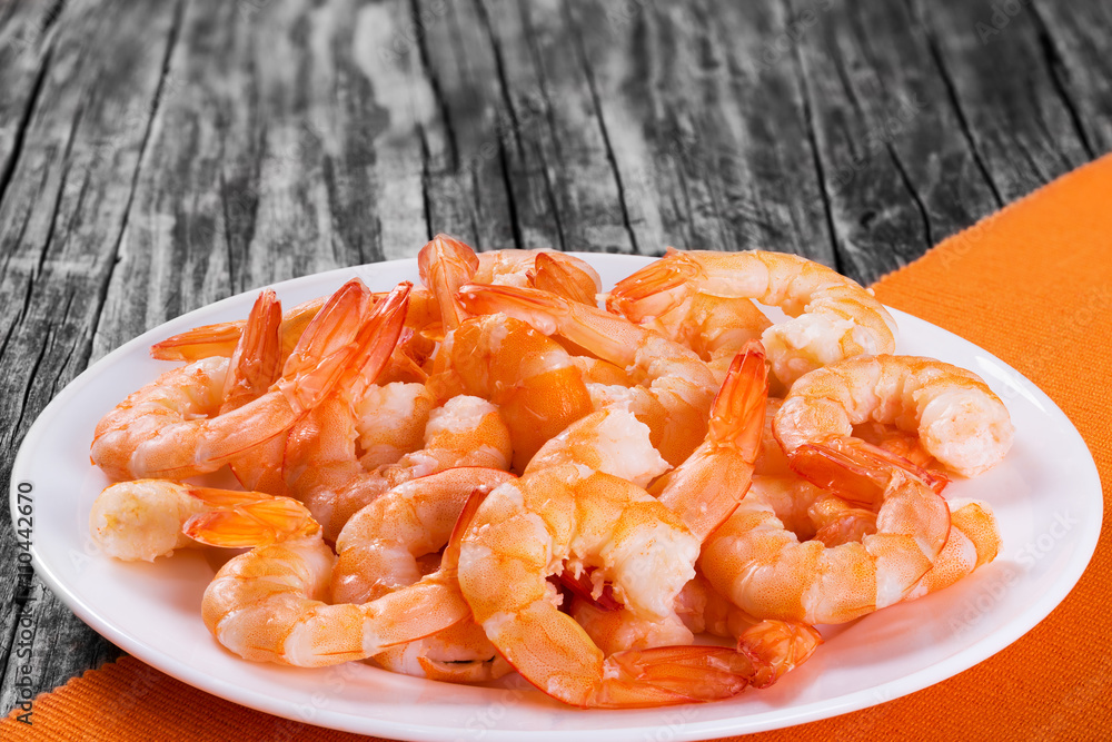 tails of shrimps on a white bowl, close-up tails of shrimps on a white bowl, close-up
