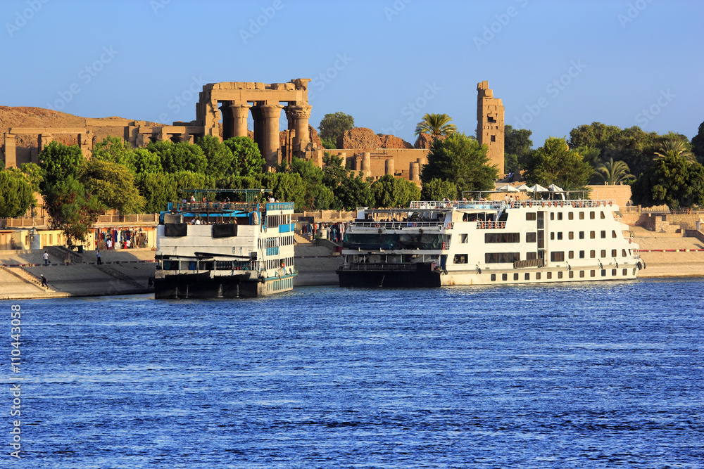 Egypt. Cruise ships docked at Kom Ombo on the Nile. The Temple of Sobek and Haroeris - seen colonnade of the Hypostyle Hall