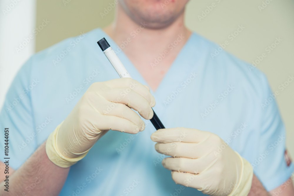 Hand of a doctor holding bottle blood sample Hand of a doctor holding bottle blood sample