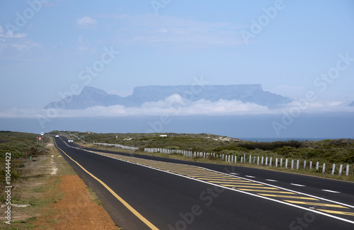 BLOUBERGSTRAND WESTERN CAPE SOUTH AFRICA - APRIL 2016 - An open coastal road heading north from Cape Town with the Table Mountain 30 kms south from Bloubergstrand on the west coast Southern Africa