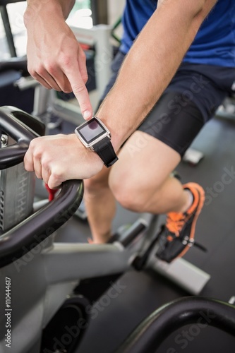 Man using smart watch while exercising