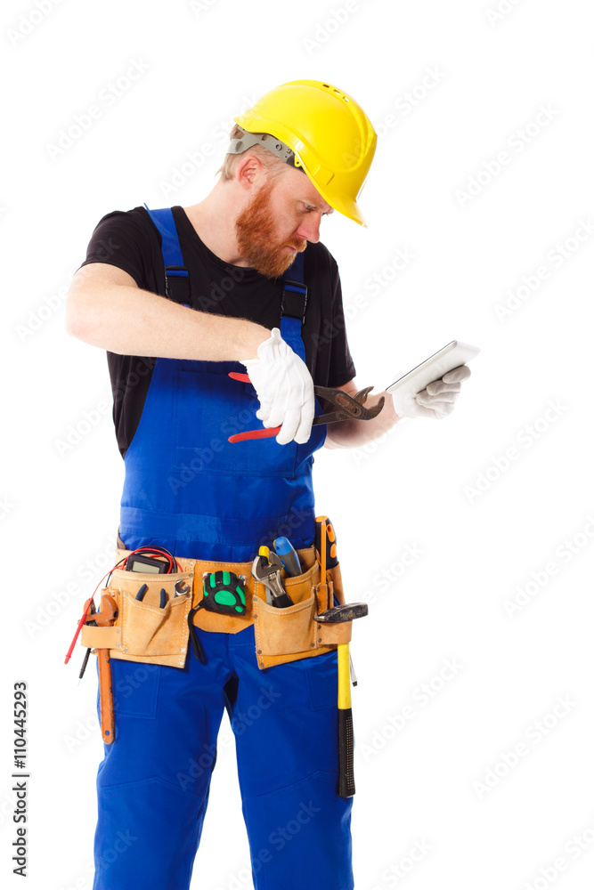 Man builder in the uniform with a tablet Man builder in the uniform with a tablet