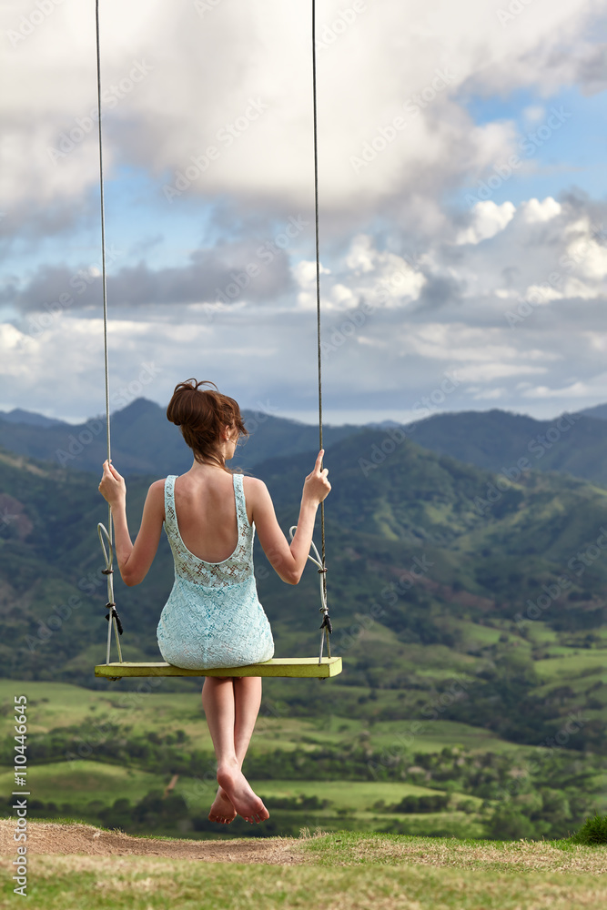 Girl dreaming on a swing 