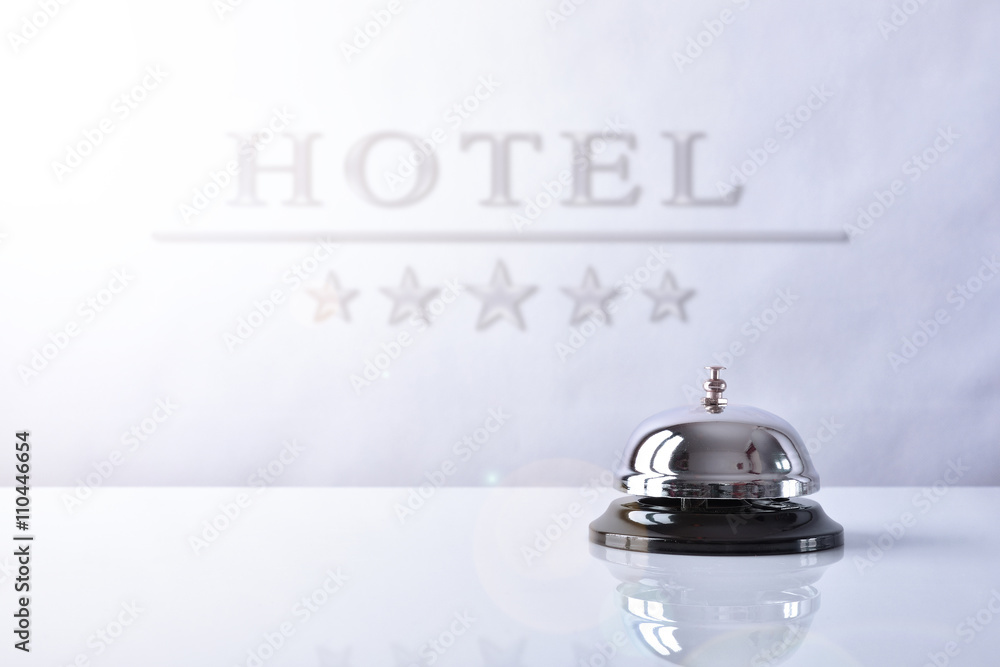 Service bell on hotel reception with Hotel placard background - obrazy, fototapety, plakaty 