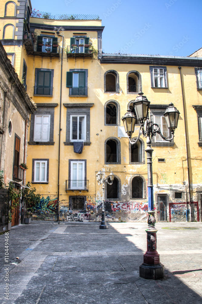 A square in the historical center of Naples in Italy with a typical lantern
