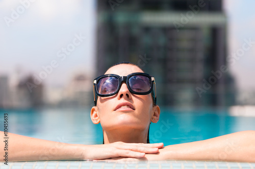 Beautiful woman relaxing in a pool. 
