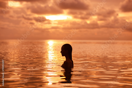 Female going for a swim at sunset. © kieferpix