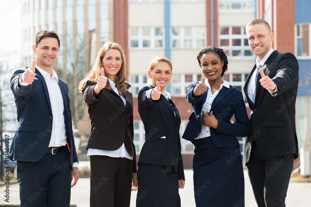 Group Of Businesspeople Showing Thumb Ups Group Of Businesspeople Showing Thumb Ups