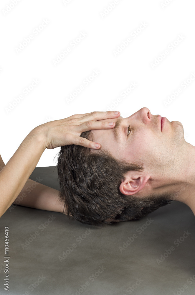 Fototapeta premium Physiotherapist doing a cranial sacral therapy to a man patient.