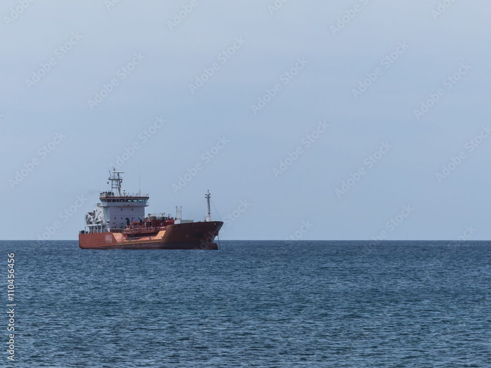 Red gas cargo ship anchoring.