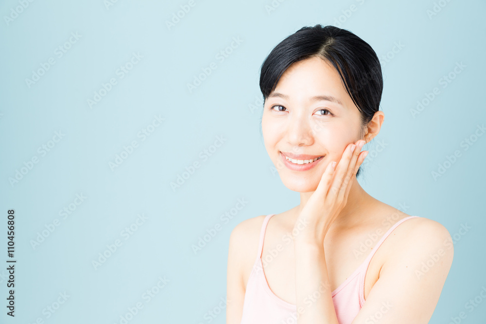 attractive asian woman skincare image on blue background attractive asian woman skincare image on blue background