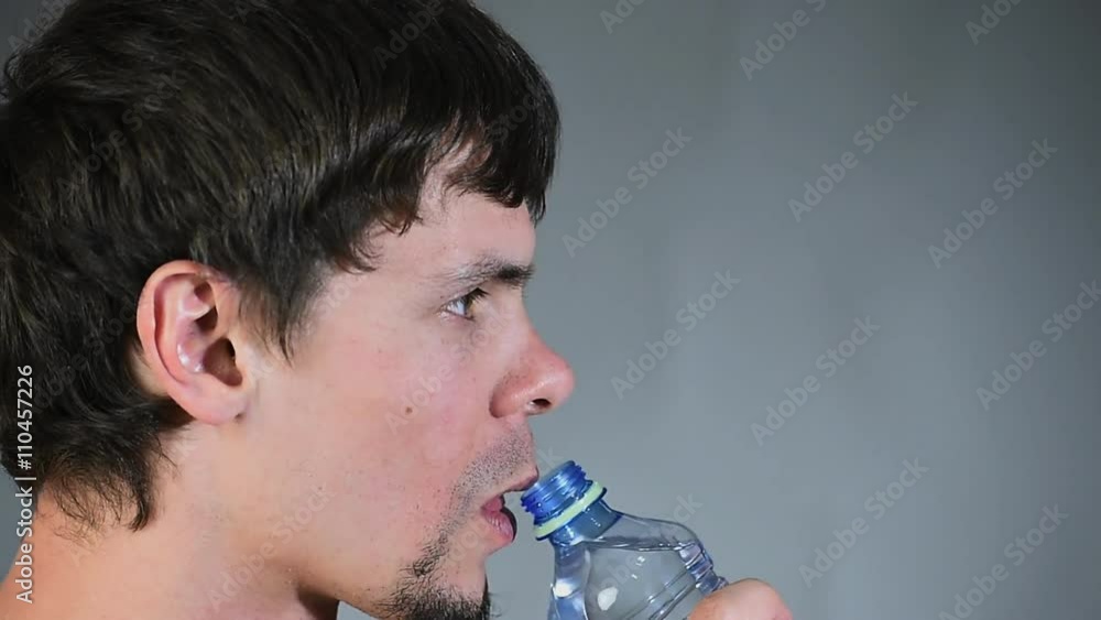 Man drinking water from plastic bottles portrait Man drinking water from plastic bottles portrait