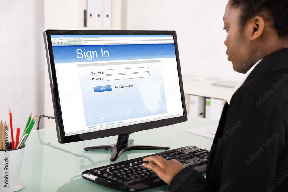 Businesswoman Signing Into Website On Computer Businesswoman Signing Into Website On Computer