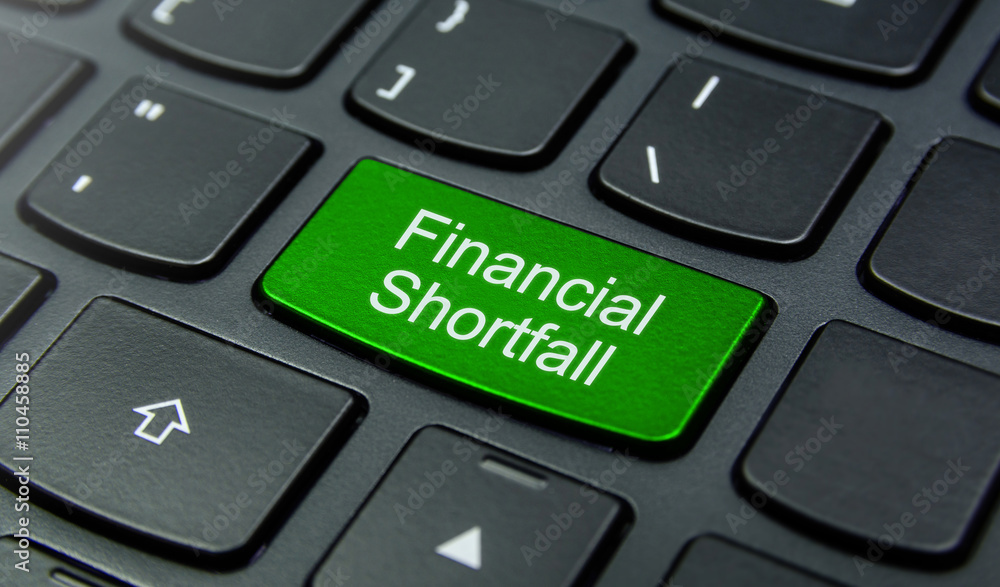 Business Concept: Close-up the Financial Shortfall button on the keyboard and have Lime, Green color button isolate black keyboard Business Concept: Close-up the Financial Shortfall button on the keyboard and have Lime, Green color button isolate black keyboard