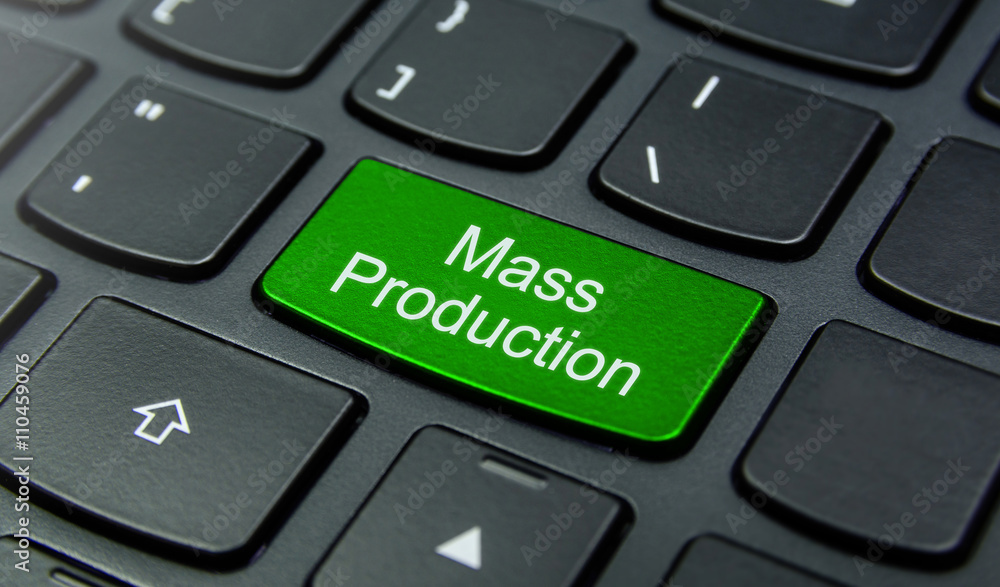 Business Concept: Close-up the Mass Production button on the keyboard and have Lime, Green color button isolate black keyboard Business Concept: Close-up the Mass Production button on the keyboard and have Lime, Green color button isolate black keyboard