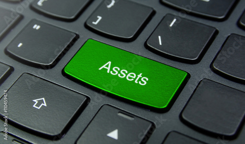 Business Concept: Close-up the Assets button on the keyboard and have Lime, Green color button isolate black keyboard
